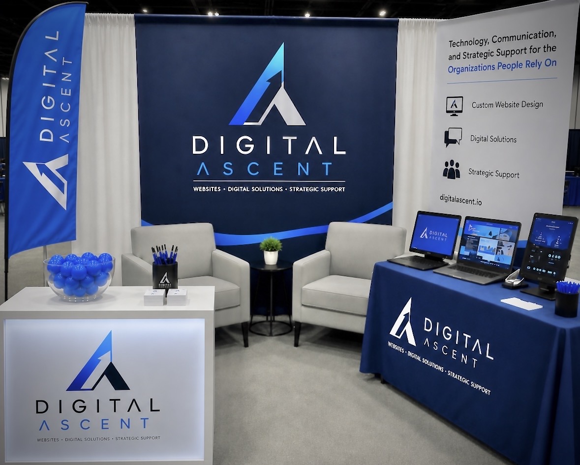 Digital Ascent conference booth featuring branded backdrop and displays showcasing digital solutions.